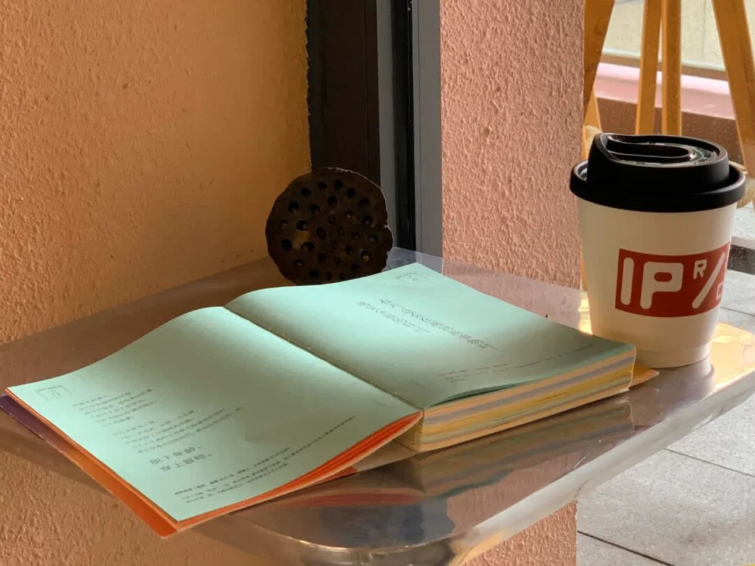 摊开的笔记与 IP Coffee 咖啡杯、木托盘